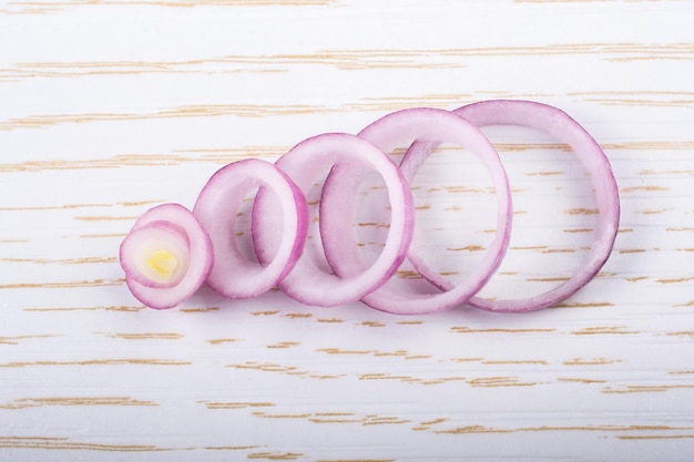 Sliced onion rings and onion slices on background