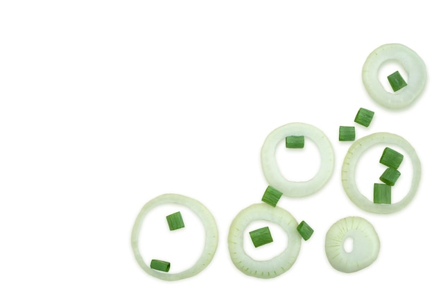 Sliced onion rings and scattered chaotically chopped green onions on a white background