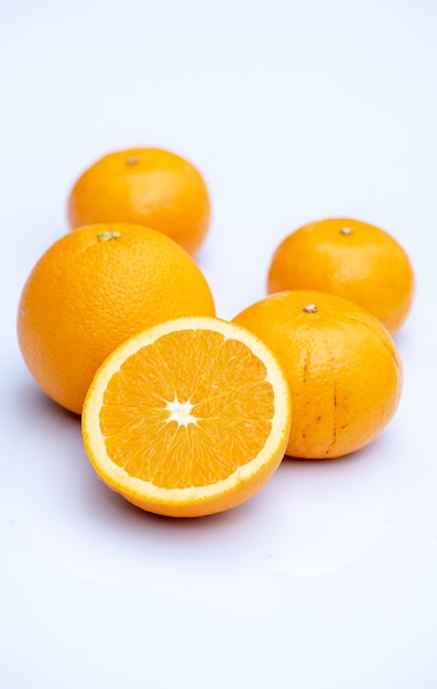 Sliced orange fruit with leaves isolated on white background