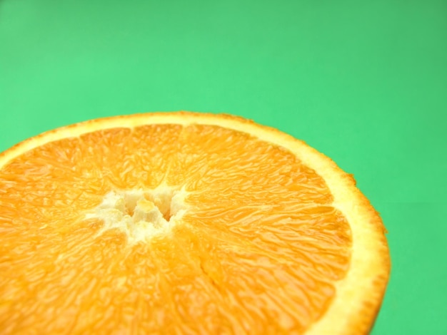 Sliced orange macro on green background