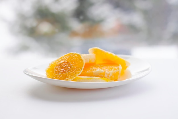 Sliced orange on a whiite plate