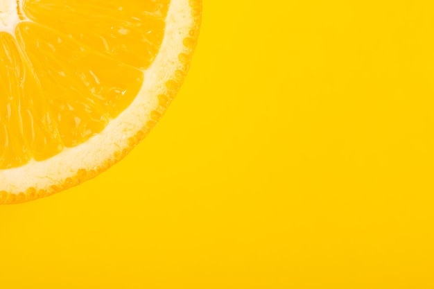 Sliced orange, yellow background, copy space. Fresh juicy fruit, source of vitamin C. Bright backdrop.