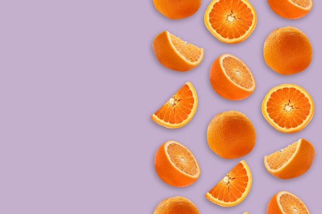 Sliced oranges on a lilic background with space for text.