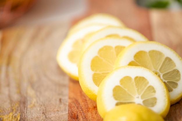 Sliced organic lemon on wood cutting board.