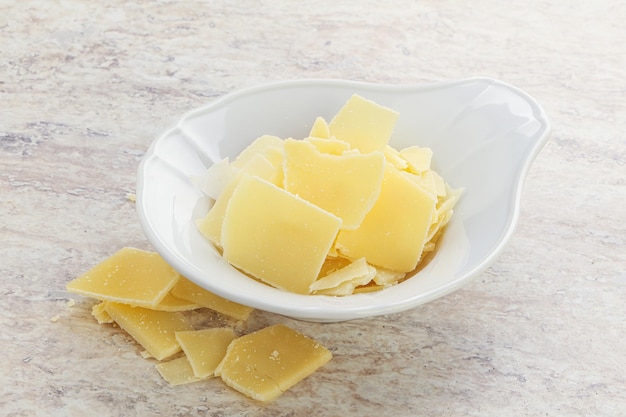 Sliced parmesan cheese heap in the bowl