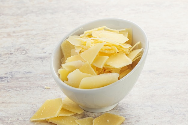 Sliced parmesan cheese heap in the bowl