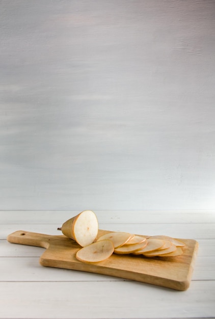 Sliced pear for making chips on white background with copy space