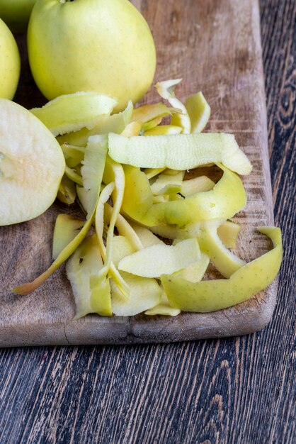 Sliced and peeled green apple on a wooden board