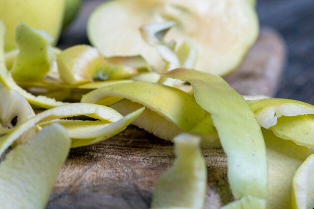 Sliced and peeled green apple on a wooden board