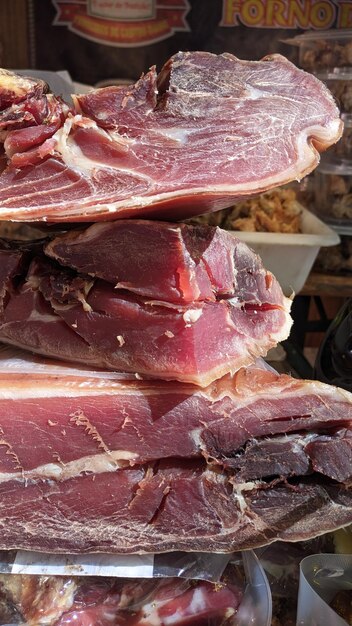 Sliced pieces of pork jerky stand on the counter in the bazaar in Lisbon