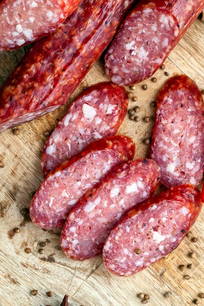 Sliced pieces of sausage from meat are lying on a cutting board