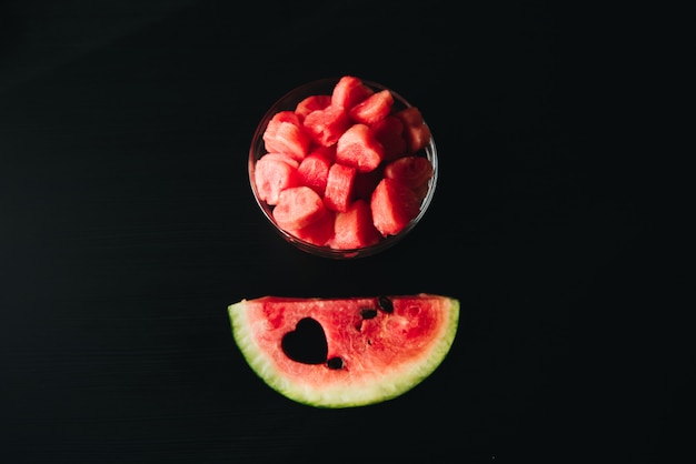 Sliced pieces of watermelon in the shape of hearts in a glass