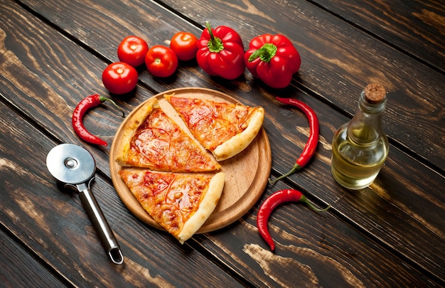 sliced ​​pizza margherita on wood background