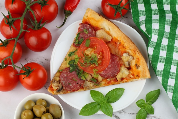 Sliced pizza on the table in the restaurant A piece of pizza on a plate