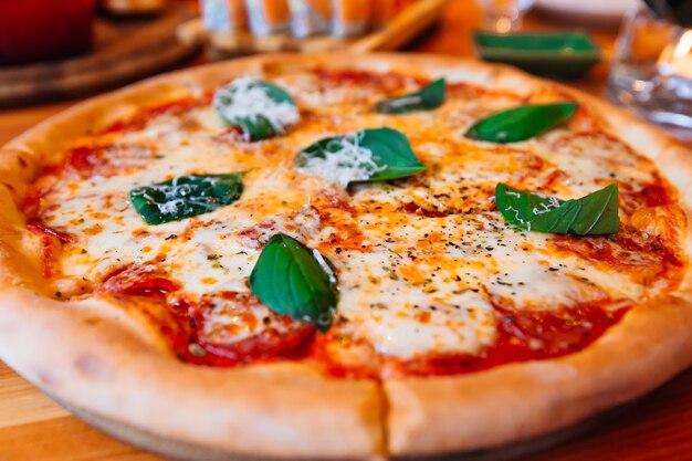 Sliced Pizza with Mozzarella cheese Tomatoes pepper Spices and Fresh Basil Italian pizza Pizza Margherita or Margarita