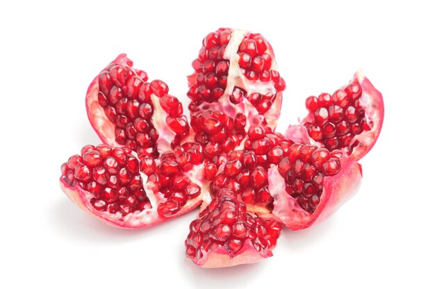 Sliced pomegranate wedges on isolated white background