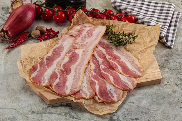 Sliced pork bacon over board