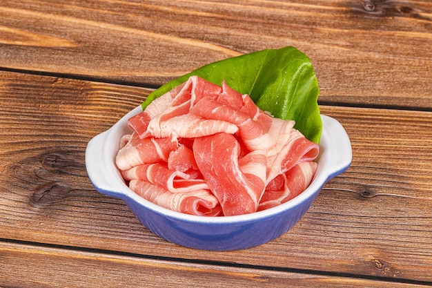 sliced pork bacon in the bowl