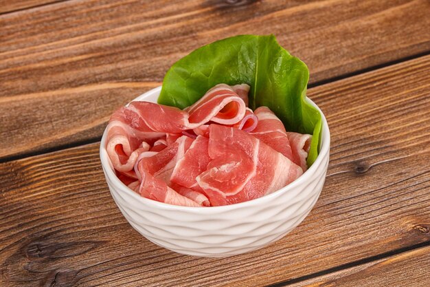 sliced pork bacon in the bowl