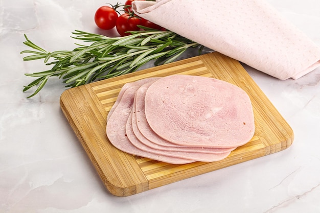 Photo sliced pork ham for sandwiches over board