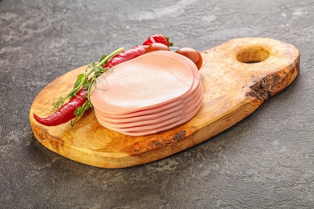 Sliced pork sausages stack over board