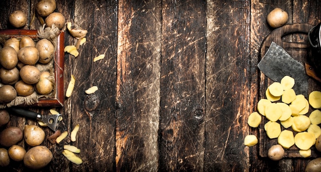 The sliced potatoes on an old wooden Board.