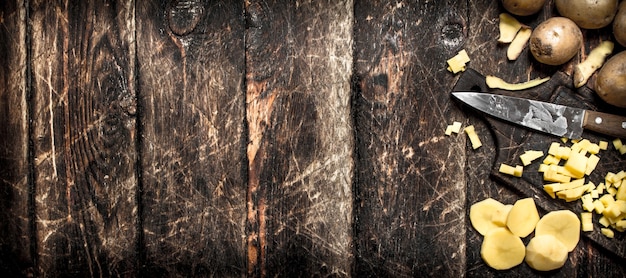 The sliced potatoes on an old wooden Board.