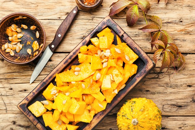 Sliced pumpkin on kitchen board