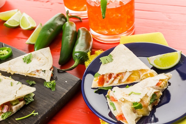 Sliced quesadilla filled with cheese, chicken and pico de gallo.