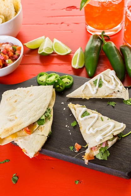 Sliced quesadilla filled with cheese, chicken and pico de gallo.