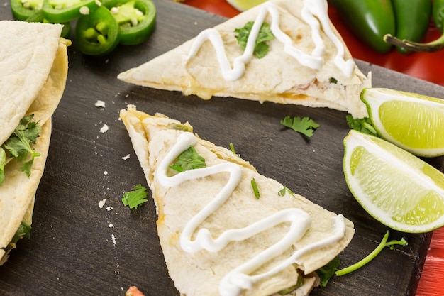 Sliced quesadilla filled with cheese, chicken and pico de gallo.