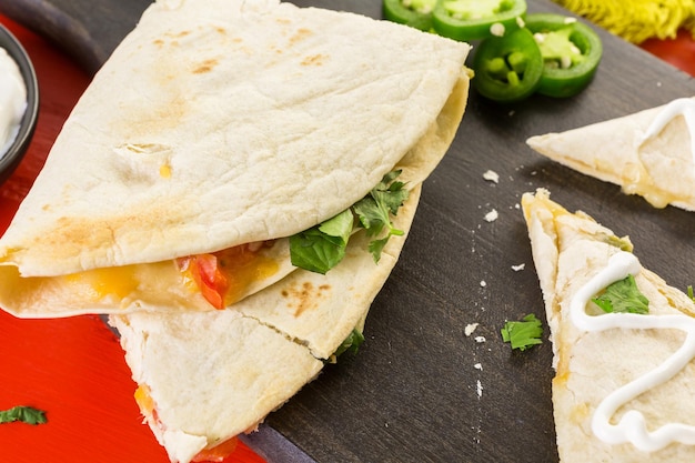 Sliced quesadilla filled with cheese, chicken and pico de gallo.