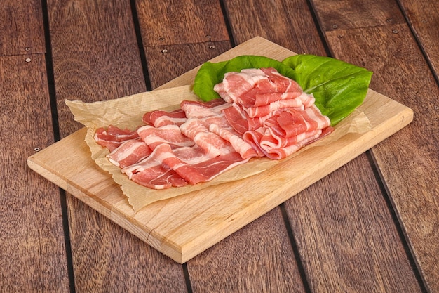 Sliced raw pork bacon in the bowl