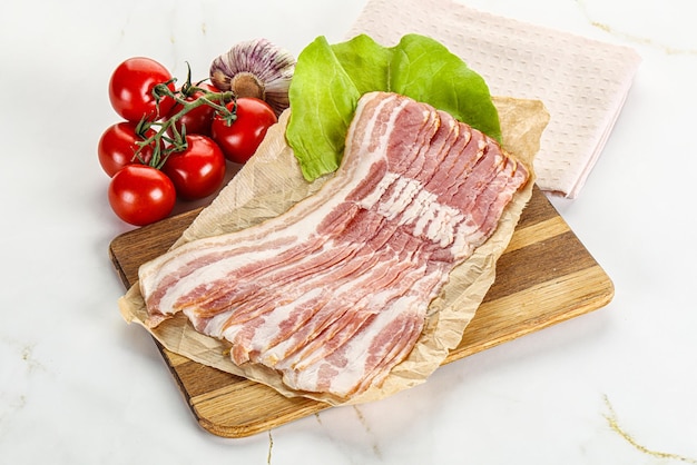 Sliced raw pork bacon oved board