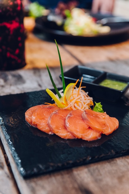 Sliced raw salmon served as appetizer