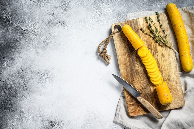 Sliced raw Yellow organic carrots on a cutting Board