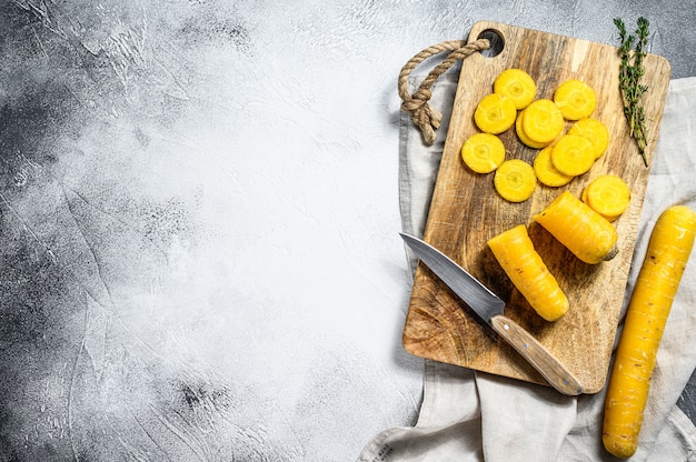 Sliced raw Yellow organic carrots on a cutting Board