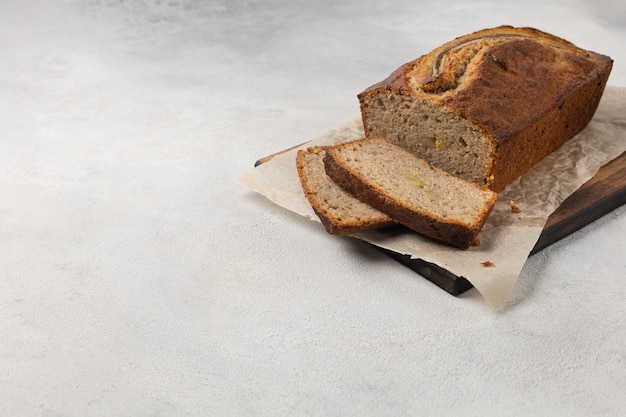 Sliced ready-made banana bread on a light background top view