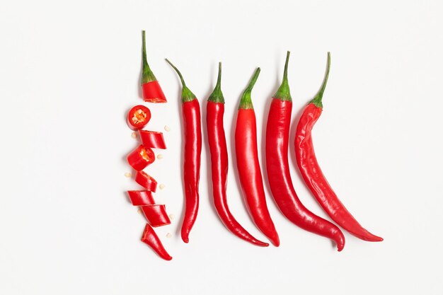 Sliced red chili pepper arranged on a plain background