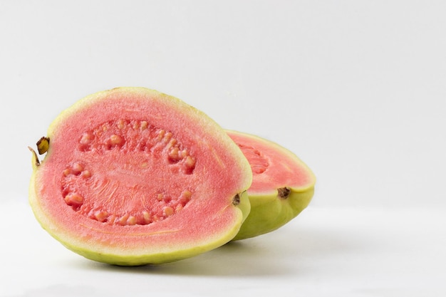 Sliced red guava on white background