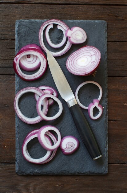 Sliced red onions on a wooden table top view