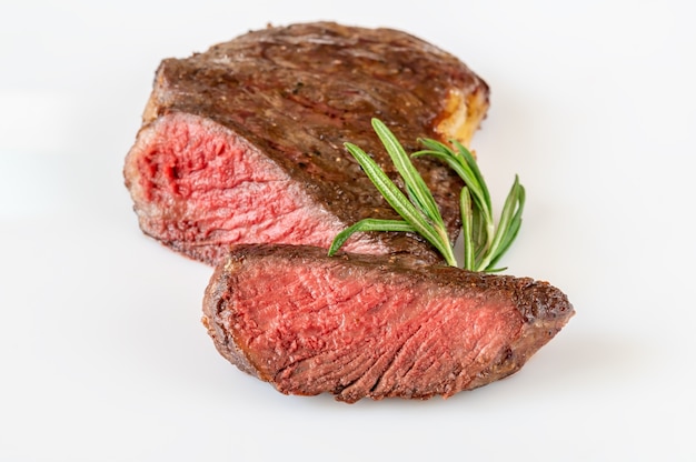 Sliced rib eye steak on white surface