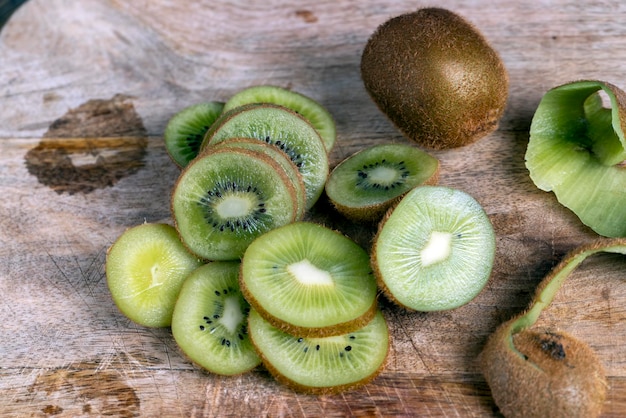 Sliced ripe green kiwi on a chopping board kiwi fruit washed and cut into pieces