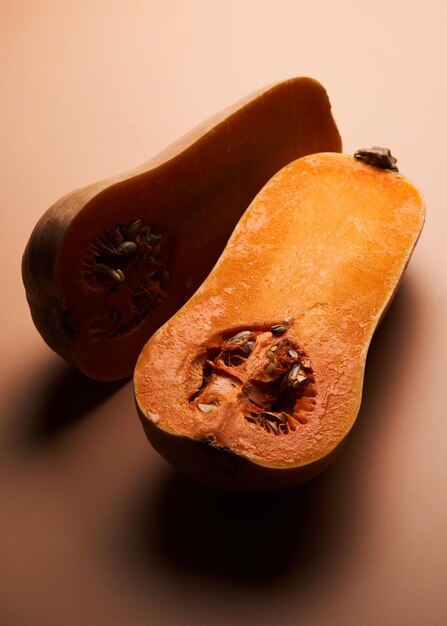 Sliced ripe pumpkin close up orange background