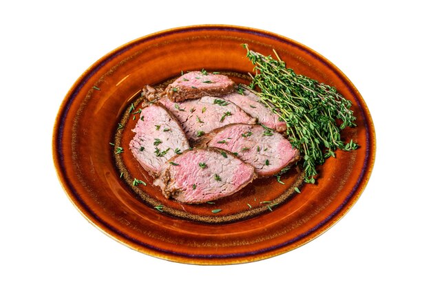 Sliced Roast beef sirloin tender steak on a rustic plate Isolated on white background