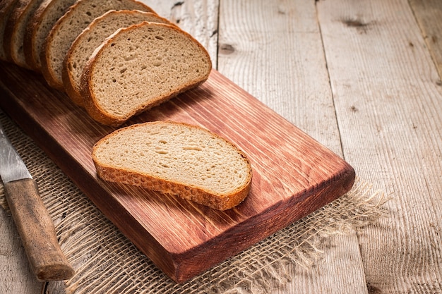 Sliced rye bread on cutting board closeup