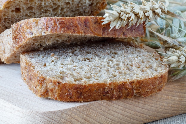 Sliced rye bread on cutting board closeup