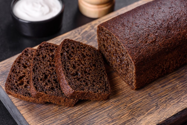 Sliced rye bread on cutting board Whole grain rye bread with seeds