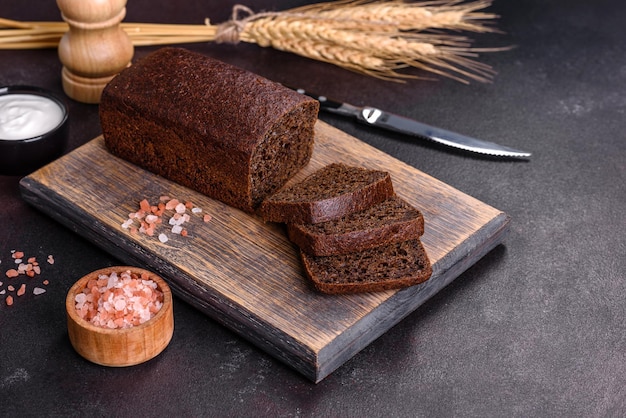 Sliced rye bread on cutting board Whole grain rye bread with seeds