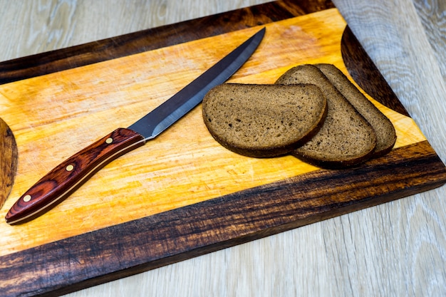 Sliced rye bread on cutting board. whole grain rye bread